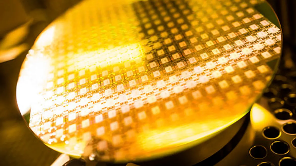 Automated machinery in a clean room manufacturing semiconductor chips for electronic devices.