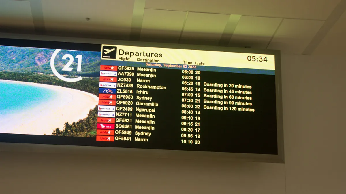Airport departure board displaying flight information